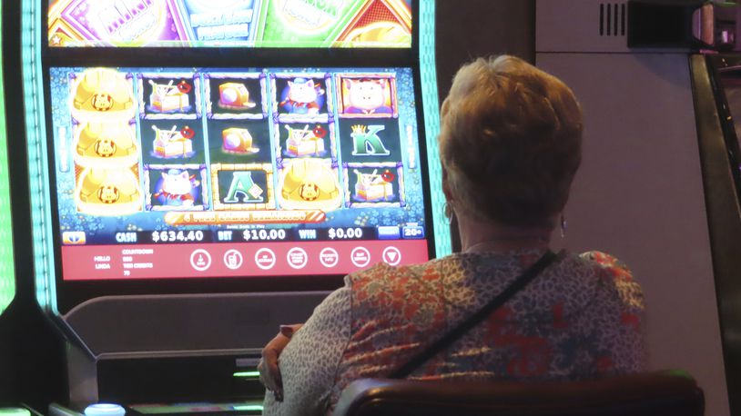 A gambler plays a slot machine at Harrah's casino in Atlantic City N.J., on Sept. 29, 2023. Figures released by New Jersey gambling regulators on April 8, 2024, show Atlantic City's nine casinos collectively reported a gross operating profit of $744.7 million in 2023, a decline of 1.6% from 2022. (AP Photo/Wayne Parry)