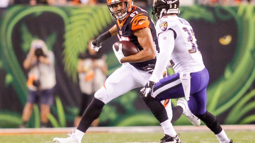 Cincinnati Bengals C.J. Uzomah carries the bal lafter making a catch during their game against the Baltimore Ravens Thursday, Sept. 13 at Paul Brown Stadium in Cincinnati. The Cincinnati Bengals defeated the Baltimore Ravens 34-23. NICK GRAHAM/STAFF