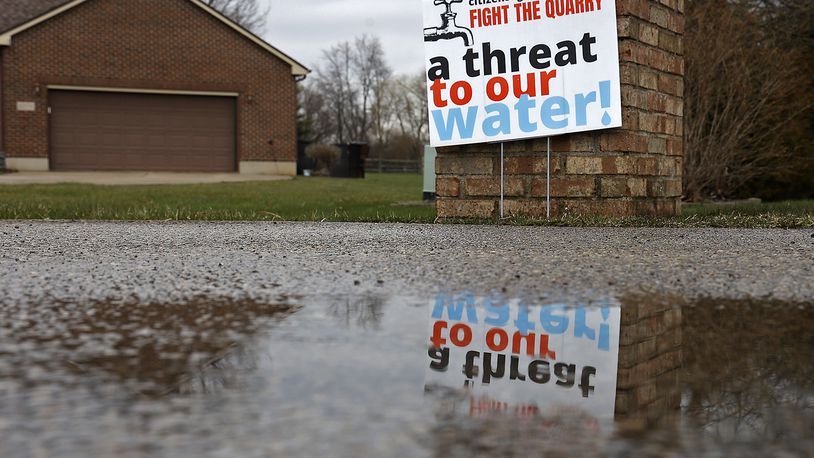 A sign in the front yard of a residence near the proposed gravel quarry Thursday, March 23, 2023. BILL LACKEY/STAFF
