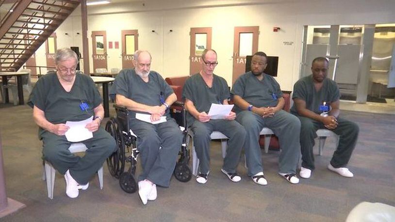 Inmates at a jail in Gwinnett County, Georgia, read a letter expressing sympathy after the shooting death of an officer.