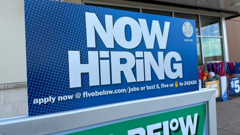 A hiring sign beckons potential employees to apply for work inside a discount store Wednesday, April 3, 2024, in Centennial, Colo. On Thursday, April 11, 2024, the Labor Department reports on the number of people who applied for unemployment benefits last week. (AP Photo/David Zalubowski)