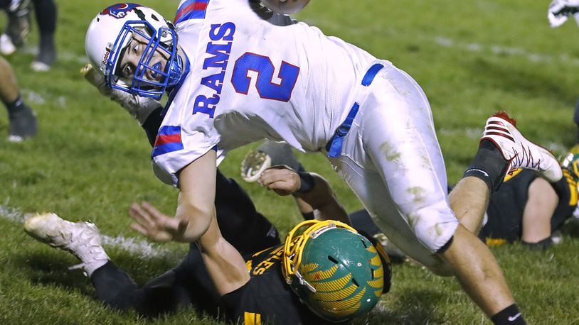 Greeneview’s Jacob Green runs over Madison-Plains’ Griffin Jones as he carries the ball. Bill Lackey/Staff