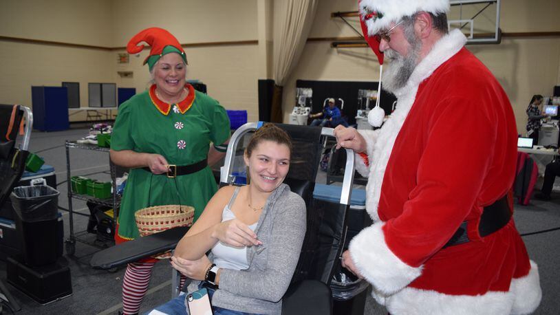 Several events will be held in Clark and Champaign counties this week, including several community blood Drives. Here, Lauren Tuttle is with Santa John Fleeger & Elf Patricia Campbell Yeary at a previous blood drive at the Maiden Lane Church of God in Springfield. Contributed/Community Blood Drive