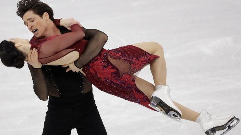 Scott Moir and Tessa Virtue of Canada perform in the ice dance free dance figure skating team event in the Gangneung Ice Arena at the 2018 Winter Olympics in Gangneung, South Korea, Monday, Feb. 12, 2018. (AP Photo/Bernat Armangue)