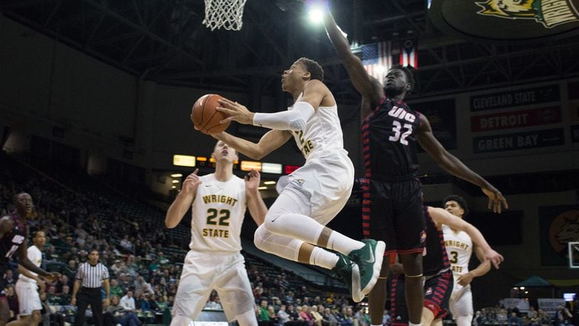 Wright State’s Everett Winchester tries to avoid a block by UIC’s Clint Robinson during the Raiders’ 65-61 win at the Nutter Center on Dec. 30. ALLISON RODRIGUEZ/CONTRIBUTED PHOTO