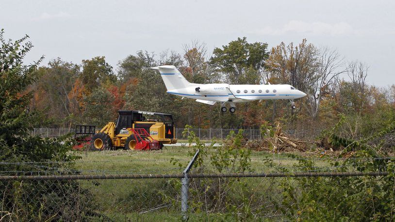 The City of Dayton is removing trees from the Wright Brothers Airport near Springboro for better runway approach clearance according to airport officials. The large trees behind this Gulfstream jet arriving at the airport last week have now been removed. Trees are also being removed near the Kauffman YMCA in Springboro. TY GREENLEES / STAFF