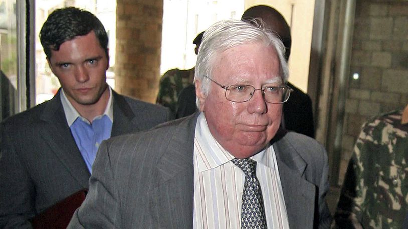 In this Oct. 7, 2008, file photo, Jerome Corsi, right, arrives at the immigration department in Nairobi, Kenya. Corsi, a conservative writer and associate of President Donald Trump confidant Roger Stone says he is in plea talks with special counsel Robert Mueller's team. Jerome Corsi told The Associated Press on Friday, Nov. 23, 2018, that he has been negotiating a potential plea but declined to comment further.