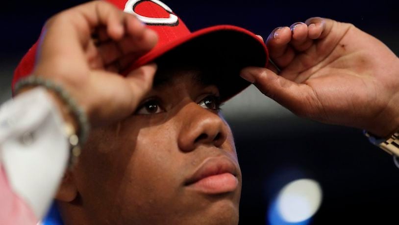 Hunter Greene, a pitcher and shortstop from Notre Dame High School in Sherman Oaks, Calif., adjusts his hat after being selected No. 2 by the Cincinnati Reds in the first round of the Major League Baseball draft, Monday, June 12, 2017, in Secaucus, N.J.(AP Photo/Julio Cortez)