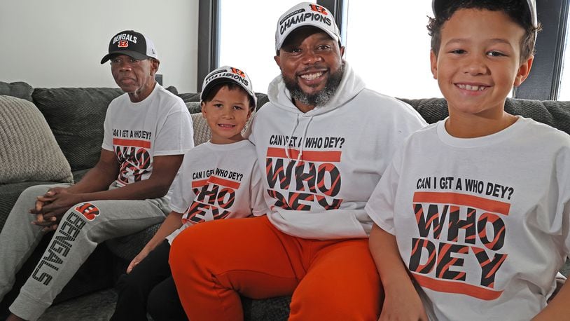 Brandon Peterson with his sons, Brandon, Jr., and Noah along with Brandon's father, Noah, ara all four Bengals fans. BILL LACKEY/STAFF