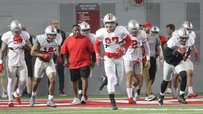 Ohio State players, including Nick Bosa (97) warm up before practice on Monday, March 26, 2018, at the Woody Hayes Athletic Center in Columbus. David Jablonski/Staff
