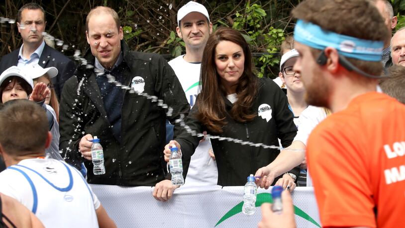 A runner squirts water towards Britain's Prince William, the Duke of Cambridge, as he hands out water to runners during the London Marathon in London, Sunday, April 23, 2017. The Duke and Duchess of Cambridge and Prince Harry, are spearheading Heads Together, in partnership with eight leading mental health charities, that are tackling stigma, raising awareness, and providing vital help for people with mental health problems. (Chris Jackson, Pool via AP) ORG XMIT: LON121