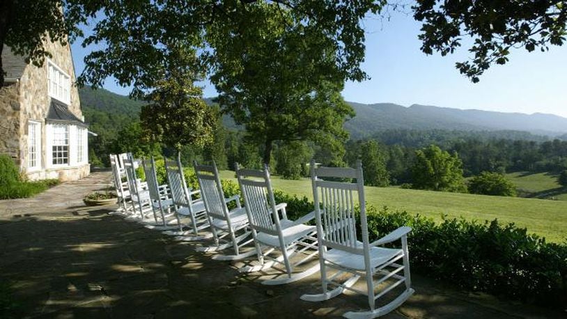 Rocking chairs are lined up outside for guests to relax while enjoying a view of the Smoky Mountains outside the Blackberry Farm main house in Walland, Tenn., on June 9, 2003. (AP Photo/Wade Payne)