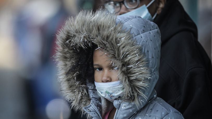In this file photo, De'Auna Jones, left and Denise Shaw wait for the bus at Main and Third Streets both wearing masks. "I am tired of wearing the mask," Shaw said, "but if its going to save lives, that why we do it."