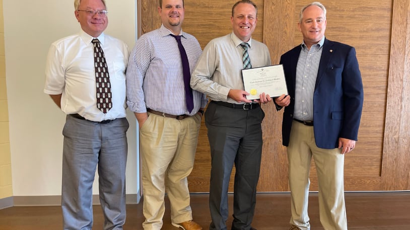 Clark-Shawnee Local School District treasurer Tom Faulkner was presented an award from the state auditor for a clean audit. From left to right: David DeHart, Board President; Brian Kuhn, Superintendent; Faulkner; and Keith Faber, Auditor of State. Contributed