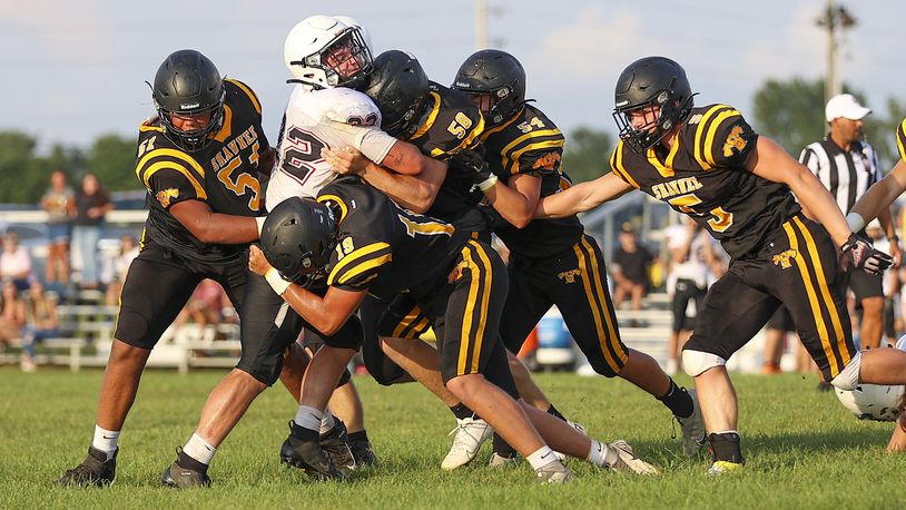 A group of Shawnee High School defenders tackle Greenon's Trevor Stewart during their scrimmage game on Friday, Aug. 13 in Springfield. CONTRIBUTED PHOTO BY MICHAEL COOPER