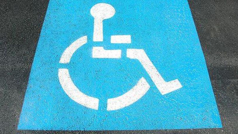 A photo of the symbol for a handicap parking space.