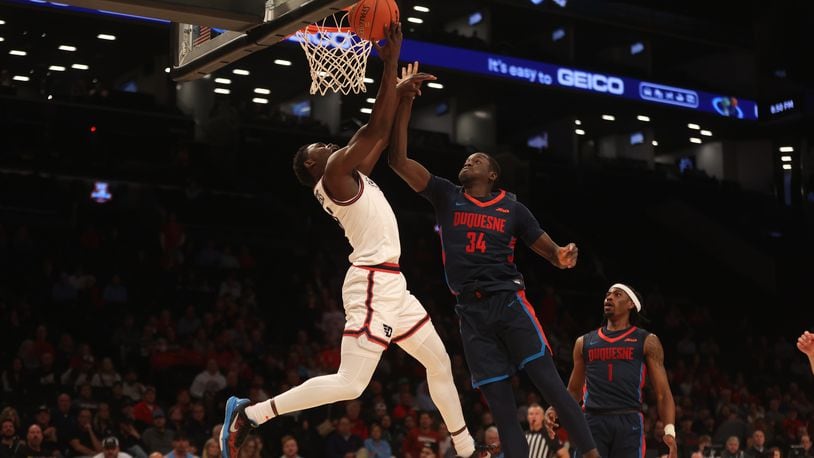 Dayton's Enoch Cheeks shoots against Duquesne in the Atlantic 10 Conference tournament quarterfinals on Thursday, March 14, 2024, at the Barclays Center in Brooklyn, N.Y. David Jablonski/Staff