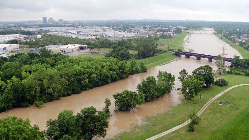 Heavy rain has the Great Miami River creeping out of its normal channel near the Kittyhawk Golf Course in Dayton. TY GREENLEES / STAFF