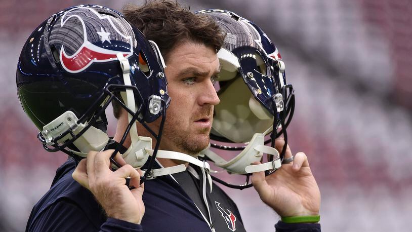 FILE - A Houston Texans staff member tests the helmet radio system before the first half of an AFC Wild Card NFL game between the Houston Texans and the Oakland Raiders, Saturday, Jan. 7, 2017, in Houston. Following a sign-stealing scandal that rocked the sport and hung over Michigan's championship run in 2023, the NCAA's football oversight committee approved Friday, April 19, 2024, the use of coach-to-player helmet communications in games for the 2024 season. The football rules committee last month made a recommendation to allow — but not require — teams at the highest tier of Division I to use radio technology similar to what NFL teams use. (AP Photo/Eric Christian Smith, File)