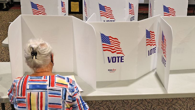 A woman casts her vote at the First Christian Church on Middle Urbana Road in Clark County. BILL LACKEY/STAFF