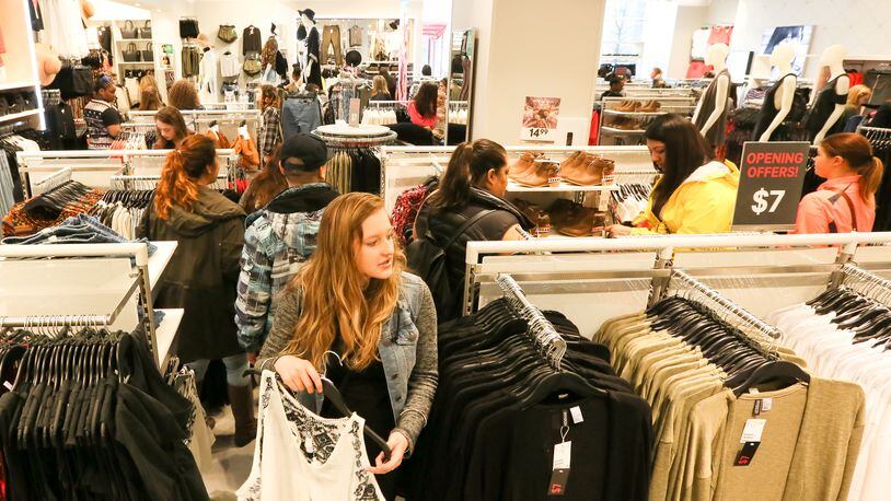Shoppers explore the new H&M at Liberty Center during their grand opening event at Liberty Center, Thursday, Mar. 31, 2016. GREG LYNCH / STAFF