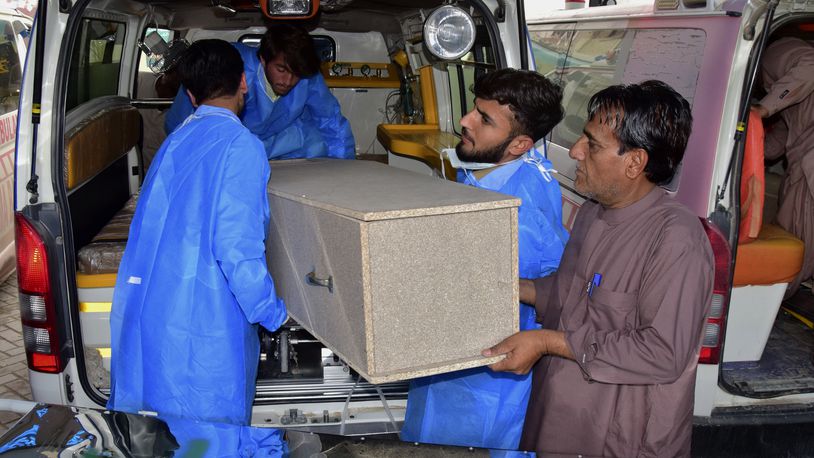 Hospital staff and volunteers unload a casket from an ambulance upon arrival at a hospital in Quetta, Pakistan, Saturday, April 13, 2024. Pakistani police are searching for gunmen who killed eight people after abducting them from a bus on a highway in the country's southwest, a police official said Saturday. Earlier, the same attackers killed two people and wounded six in another car they forced to stop. (AP Photo/Arshad Butt)