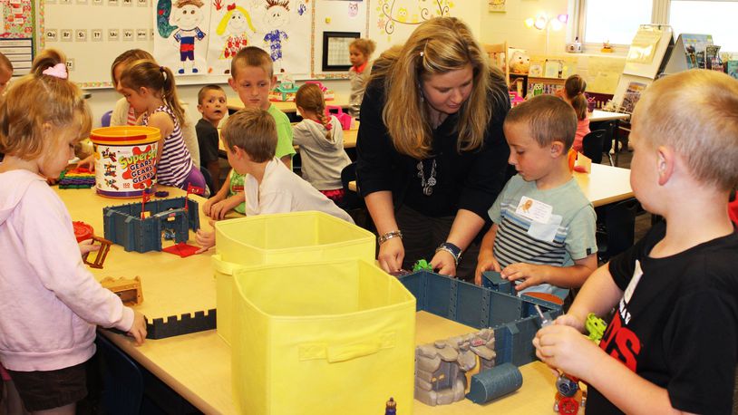 Northwestern Elementary kindergarten teacher Lauri McCutcheon helps students with a class project a few years ago. FILE