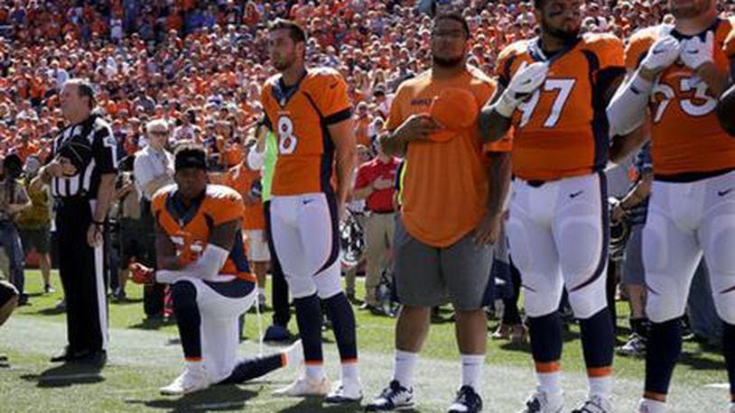In this Sept. 18, 2016, file photo, Denver Broncos inside linebacker Brandon Marshall takes a knee during the national anthem before an NFL football game against the Indianapolis Colts in Denver. Marshall posted a racist, threatening letter he received denouncing him for taking a knee during the anthem earlier this season.