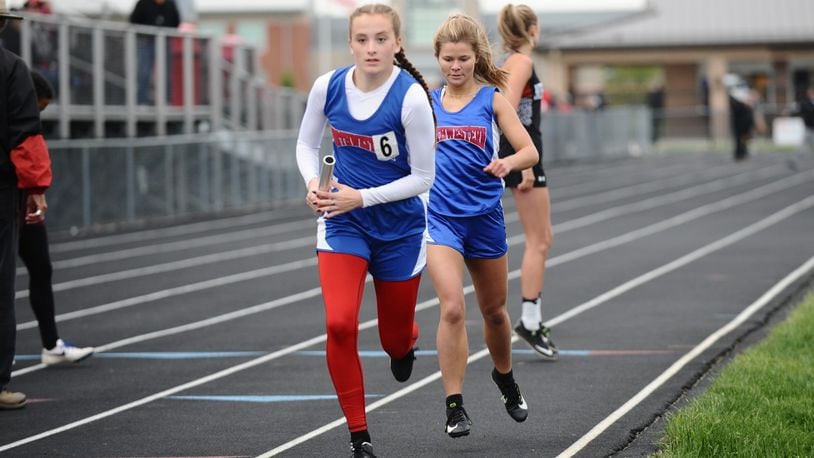Northwestern’s Stephanie White, taking the baton from teammate Marley Hosier during the 1,600-meter relay, won the Mad River Division’s 400 dash at the Central Buckeye Conference meet on Friday. Greg Billing / Contributed
