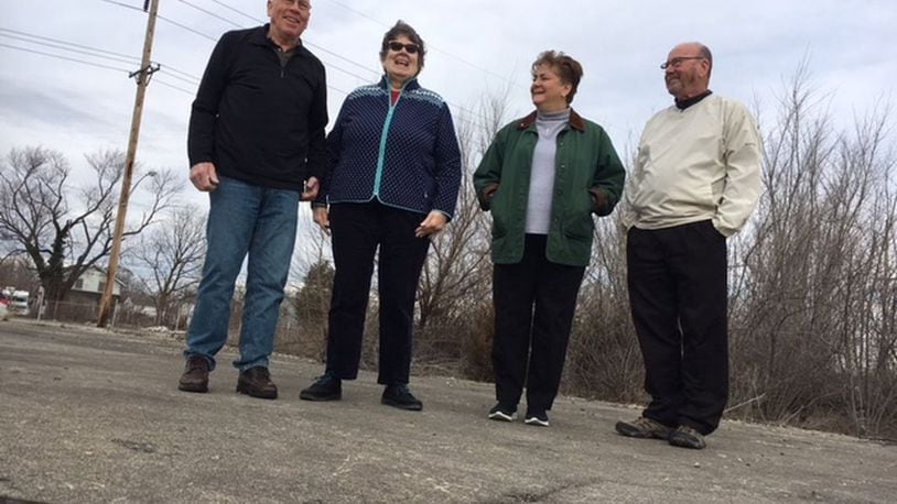Dayton-area Delphi salaried retirees (from left), Tom Rose, Mary Miller, Marlane Bengry and Tom Green, standing on the foundation of the former Delphi Wisconsin Boulevard plant in Dayton in March 2018. THOMAS GNAU/STAFF