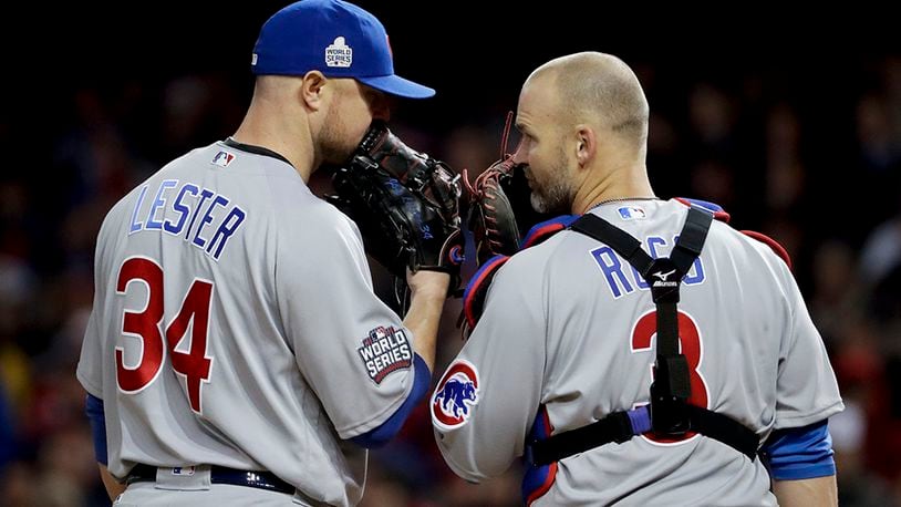 Chicago Cubs starting pitcher Jon Lester, left, and catcher David Ross talk during the sixth inning of Game 1 of the Major League Baseball World Series against the Cleveland Indians Tuesday, Oct. 25, 2016, in Cleveland. (AP Photo/Matt Slocum)