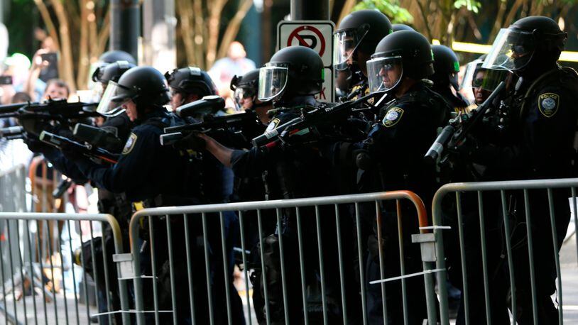 Police disperse clashing protesters as problems occurred when two opposing groups took to the streets in Portland, Oregon, on Saturday.