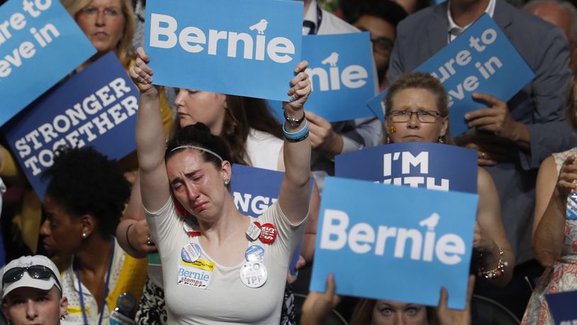 A disappointed supporter for Former Democratic presidential candidate, Sen. Bernie Sanders, I-Vt., holds up her sign during the first day of the Democratic National Convention in Philadelphia , Monday, July 25, 2016. (AP Photo/Mary Altaffer)