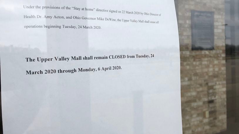 The sign on the door at the Upper Valley Mall explains why they are closed through Monday, April 6 due to the stay-at-home order. BILL LACKEY/STAFF
