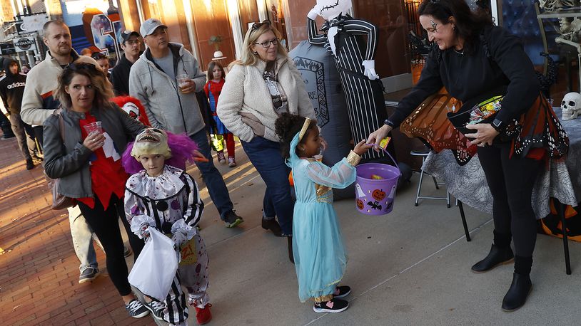 Hundreds of families came out Friday night, Oct. 28, 2022 for the thrid annual Downtown Trick or Treat event in Springfield. More than 20 businesses in the downtown area, along with community groups passed out candy and goodie bags along Fountain Avenue. BILL LACKEY/STAFF
