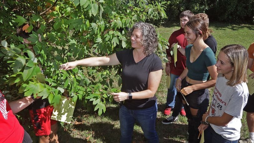 Angela Jones, Tecumseh High School science teacher, takes her conservation science class outside to identify plants. BILL LACKEY/STAFF