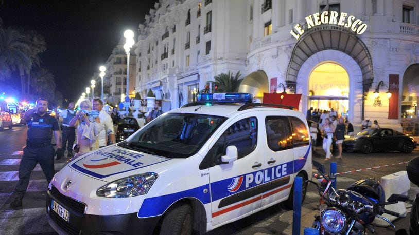 A Police car is parked near the scene of an attack after a truck drove on to the sidewalk and plowed through a crowd of revelers who'd gathered to watch the fireworks in the French resort city of Nice, southern France, Friday, July 15, 2016. A spokesman for France's Interior Ministry says there are likely to be "several dozen dead" after a truck drove into a crowd of revelers celebrating Bastille Day in the French city of Nice. (AP Photo/Christian Alminana)
