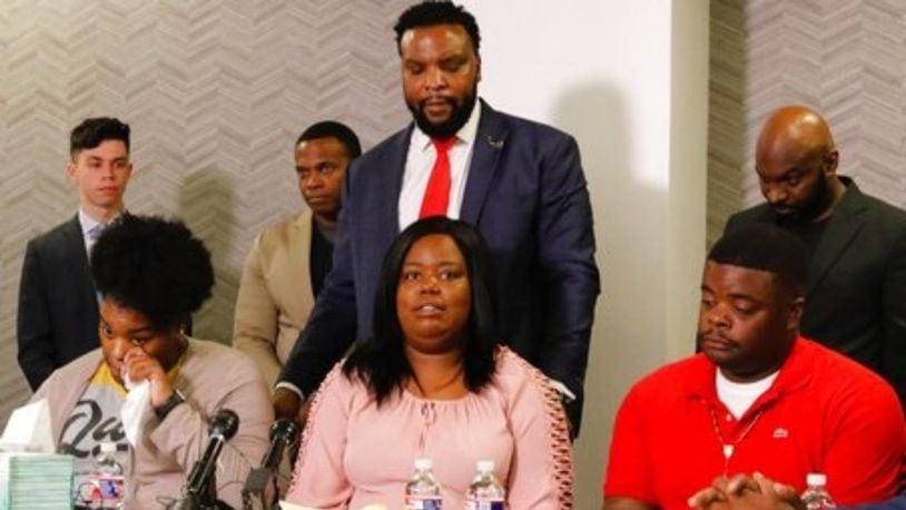 Amber Carr, left, wipes a tear as her sister Ashley Carr, center, talks about their sister, Atatiana Jefferson, as their brother, Adarius Carr, right and attorney Lee Merritt, standing, listen during a news conference Monday,