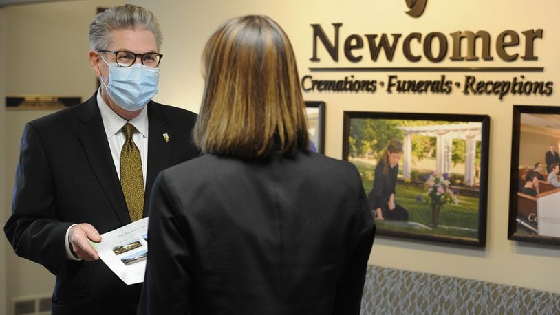 In this file photo, Jed J. Dunnichay, Funeral Director for Newcomer, talks with a potential client Friday, Dec. 18, 2020 at the Newcomer Cremations, Funerals and Receptions location in Centerville. MARSHALL GORBY\STAFF