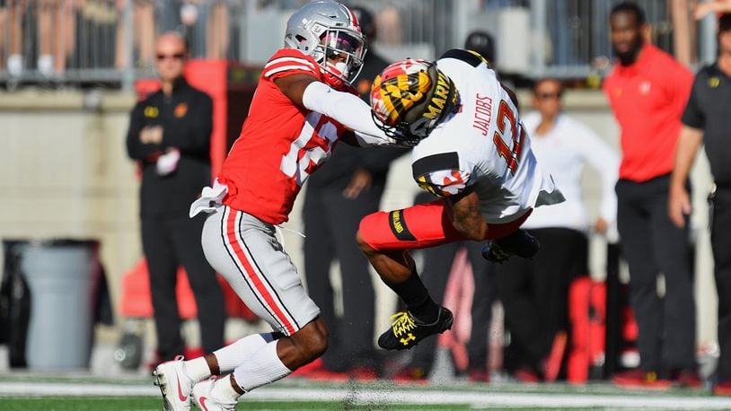 COLUMBUS, OH - OCTOBER 7: Denzel Ward #12 of the Ohio State Buckeyes hits Taivon Jacobs #12 of the Maryland Terrapins after a reception in the first quarter at Ohio Stadium on October 7, 2017 in Columbus, Ohio. Ward was ejected from the game after being assessed a targeting penalty for the hit. (Photo by Jamie Sabau/Getty Images)