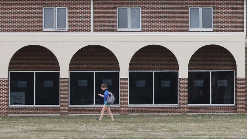 A student at Urbana University walks past the arches on one of the residence hall as she makes her way across campus Monday, March 26, 2018. Bill Lackey/Staff