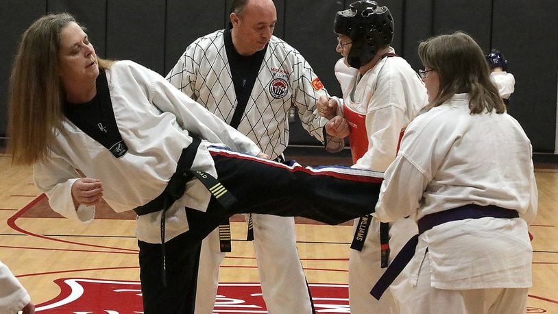 Rick and Tarole Lloyd work with students in their Tae Kwon Do class at the Springfield Salvation Army. BILL LACKEY/STAFF