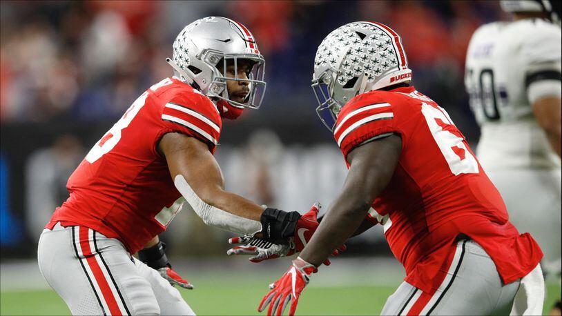 Jonathan Cooper (left) and Wayne High School graduate Robert Landers of the Ohio State Buckeyes celebrate after a defensive play against the Northwestern Wildcats in the second quarter at Lucas Oil Stadium last season. (Photo by Joe Robbins/Getty Images)