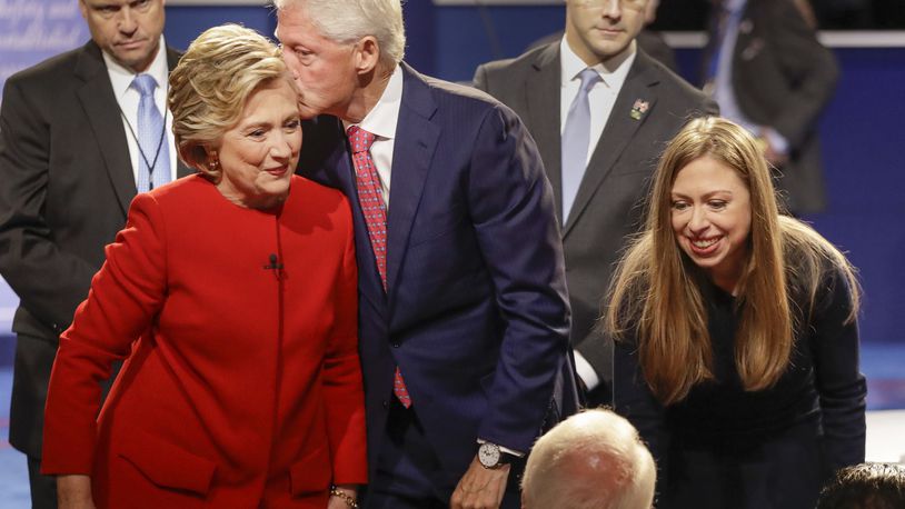Former President Bill Clinton kisses Democratic presidential nominee Hillary Clinton as she and their daughter Chelsea Clinton greet supports during the presidential debate at Hofstra University in Hempstead, N.Y., Monday, Sept. 26, 2016. (AP Photo/David Goldman)