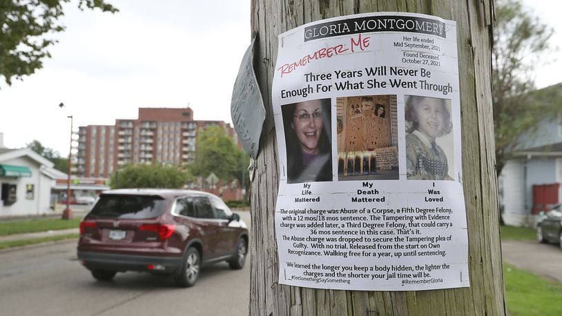 Flyers are stapled to utility poles in the North Douglas Avenue neighborhood where Gloria Montgomery's body was found in a duplex in October 2021. Eric Beedy, Montgomery's boyfriend, was sentenced to three years in prison for tampering with evidence in the case. BILL LACKEY/STAFF