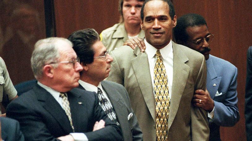 FILE - In this Oct. 3, 1995 file photo, attorney Johnnie Cochran Jr. holds O.J. Simpson as the not guilty verdict is read in a Los Angeles courtroom during his trial in Los Angeles. Defense attorneys F. Lee Bailey, left, Robert Kardashian look on. Simpson, the decorated football superstar and Hollywood actor who was acquitted of charges he killed his former wife and her friend but later found liable in a separate civil trial, has died. He was 76. (Myung J. Chun/Los Angeles Daily News via AP, Pool, File)