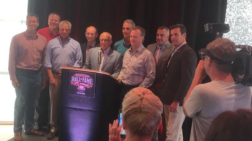 Marty Brennaman poses for a photo with his fellow Reds broadcasters after a press conference at the Reds Hall of Fame and Museum on Friday, Aug. 16, 2019, at Great American Ball Park in Cincinnati.