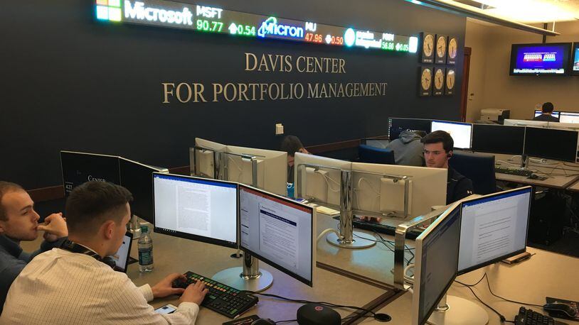 Students work in the University of Dayton’s Davis Center. Students in the center manage a $30-million stock portfolio for the university and regularly beat market benchmarks.