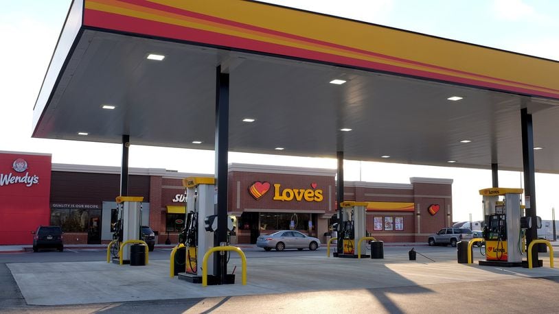 The Love’s Travel Stop at the intersection of I-70 and Route 41 held its ribbon-cutting on Tuesday, donating $2,000 to the United Way of Clark, Champaign and Madison Counties. BILL LACKEY/STAFF