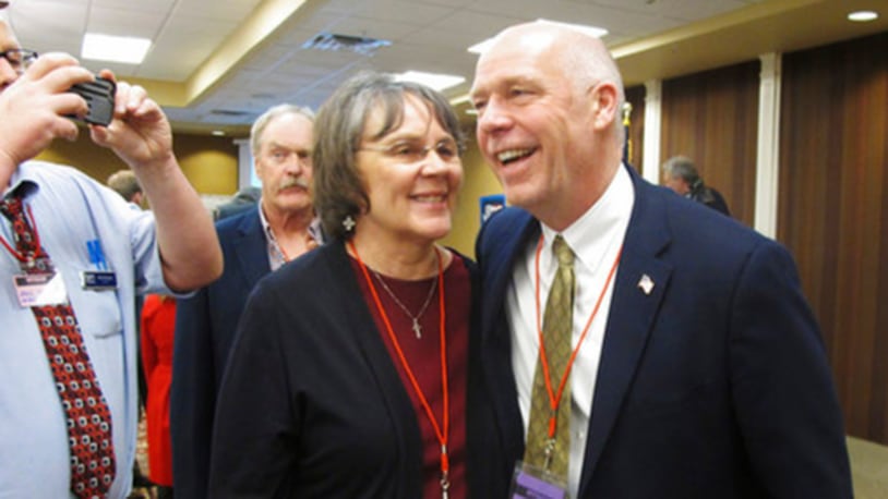 FILE - In this March 6, 2017, file photo, Greg Gianforte, right, receives congratulations from a supporter in Helena, Mont., after winning the Republican nomination for Montana's special election for the U.S. House. The technology entrepreneur's substantial wealth has become a focus in the May 25 special congressional election. Democrat Rob Quist and Libertarian Mark Wicks are also vying to become Montana's sole representative in the U.S. House. (AP Photo/Matt Volz, File)
